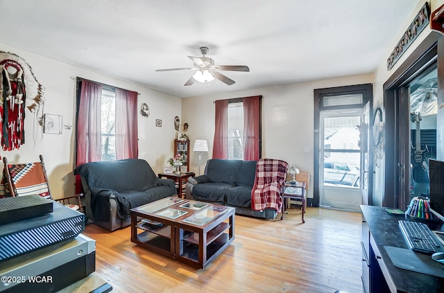 living room with ceiling fan and light hardwood / wood-style flooring