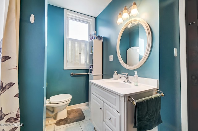 bathroom featuring vanity, toilet, and tile patterned flooring