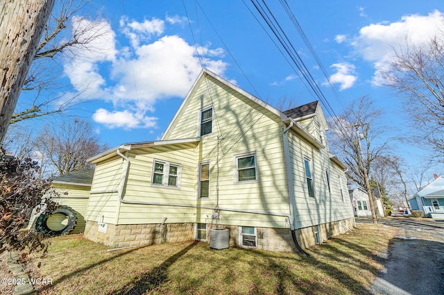 view of home's exterior with a yard and central air condition unit