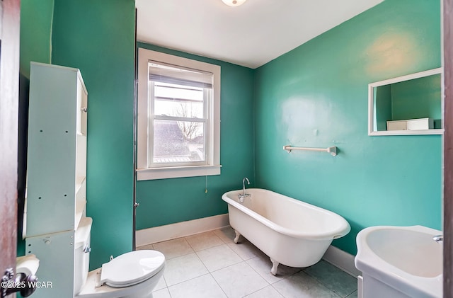 bathroom with toilet, a bathing tub, and tile patterned flooring