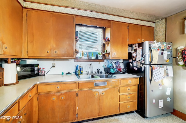 kitchen featuring sink and stainless steel fridge