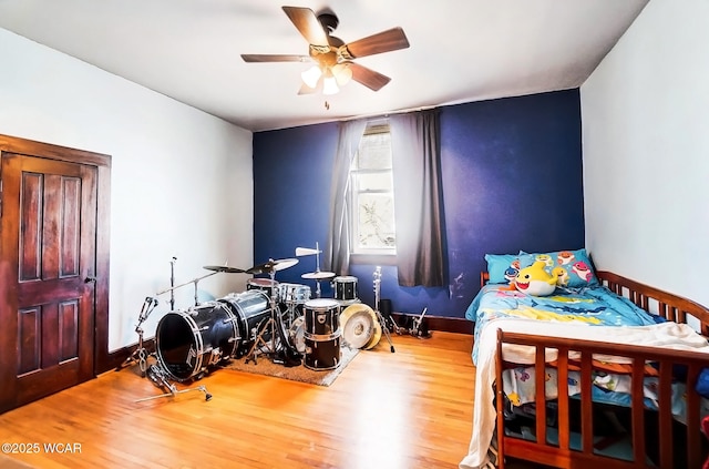 bedroom featuring hardwood / wood-style flooring and ceiling fan