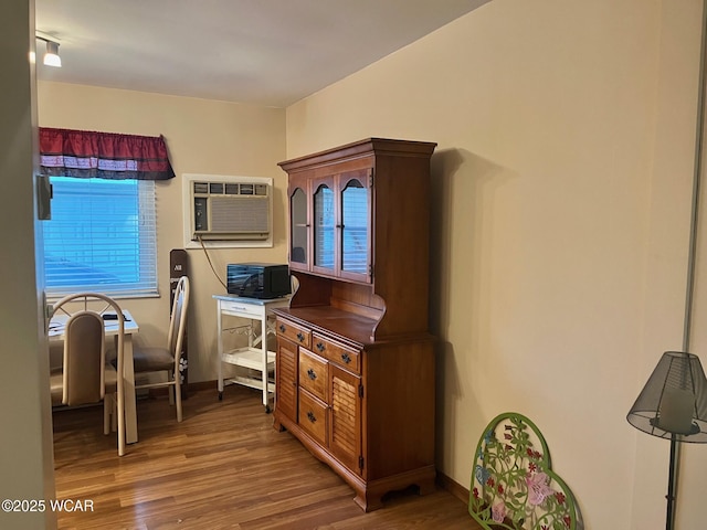 1121 Bahama Dr, Lima, OH 45801 - home office with an AC wall unit, wood finished floors, and baseboards