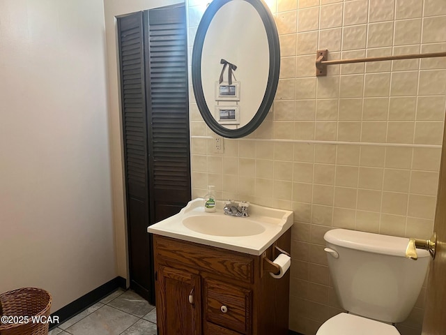 1121 Bahama Dr, Lima, OH 45801 - bathroom with toilet, vanity, tile patterned floors, baseboards, and a closet