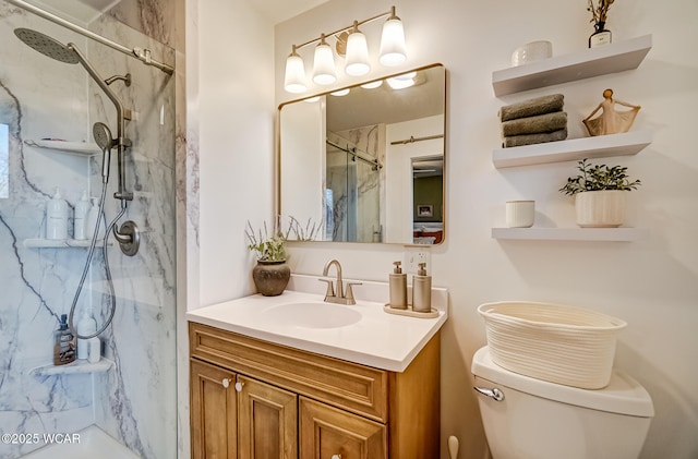 bathroom with a marble finish shower, toilet, and vanity