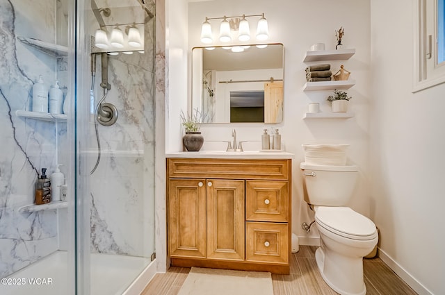 bathroom featuring toilet, a marble finish shower, vanity, baseboards, and wood tiled floor