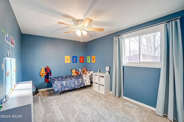 bedroom featuring visible vents, baseboards, carpet, and a ceiling fan