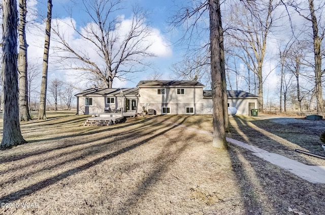 view of front of property with a wooden deck and driveway