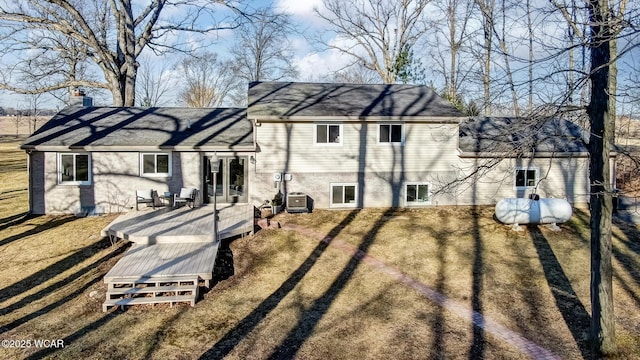 back of property featuring a chimney, central air condition unit, driveway, and a wooden deck