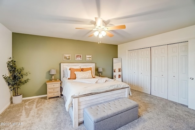 carpeted bedroom with a closet, baseboards, and a ceiling fan