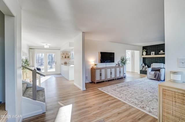 living area featuring a fireplace and wood finished floors