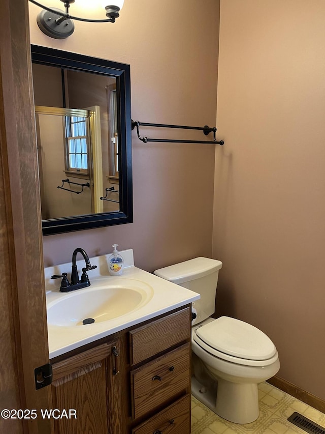 bathroom featuring vanity and toilet