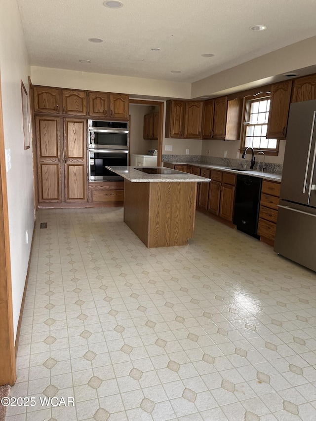 kitchen featuring a center island, sink, and black appliances