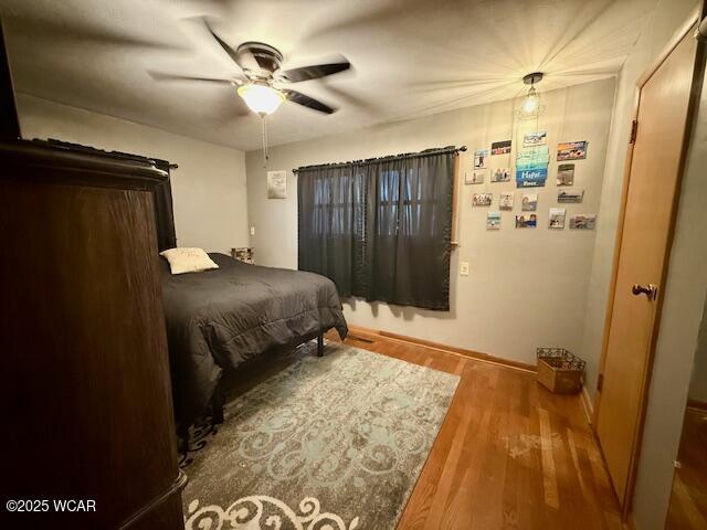 bedroom with ceiling fan and wood finished floors