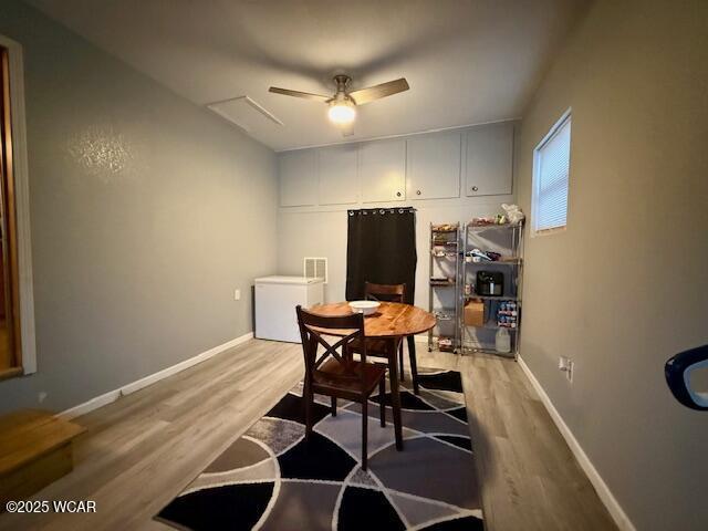 dining room with light wood-style floors, ceiling fan, and baseboards