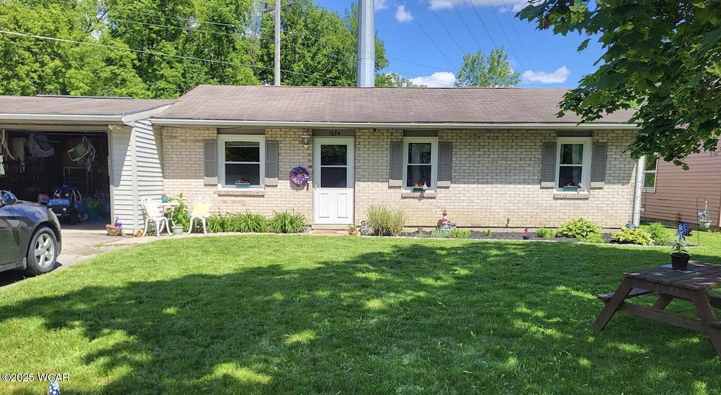 1624 N N Central Ave, Lima, OH 45801 - ranch-style home with brick siding, a front lawn, a garage, driveway, and roof with shingles