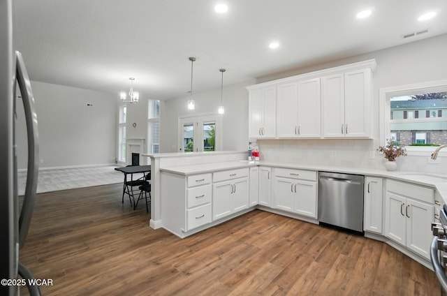 1291 Madison Blvd, Van Wert, OH 45891 - kitchen with visible vents, stainless steel dishwasher, a sink, freestanding refrigerator, and dark wood-style floors