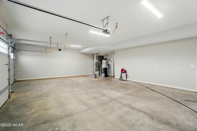 1291 Madison Blvd, Van Wert, OH 45891 - garage featuring baseboards, a garage door opener, and electric water heater