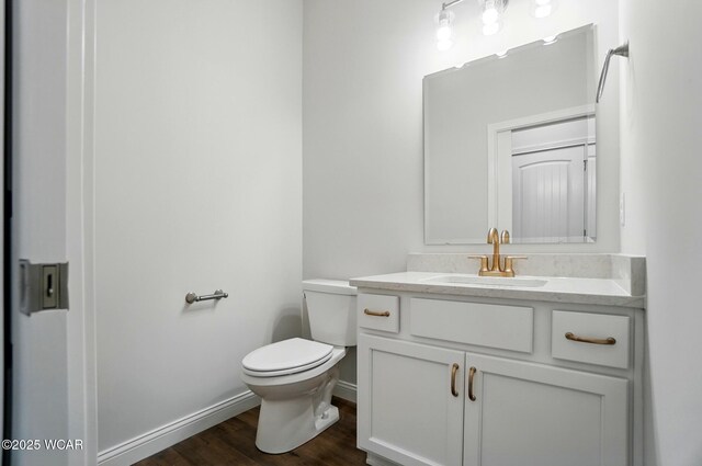 1291 Madison Blvd, Van Wert, OH 45891 - bathroom with toilet, baseboards, wood finished floors, and vanity