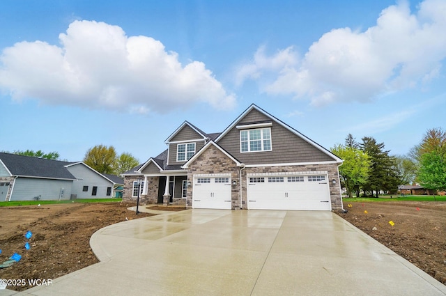 1291 Madison Blvd, Van Wert, OH 45891 - craftsman-style home featuring concrete driveway, an attached garage, and stone siding