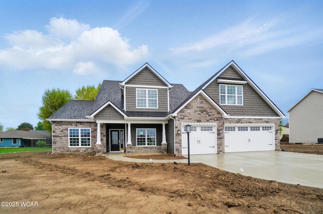 1291 Madison Blvd, Van Wert, OH 45891 - craftsman inspired home featuring a garage, a shingled roof, driveway, and stone siding