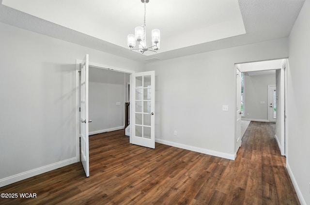 1291 Madison Blvd, Van Wert, OH 45891 - empty room with baseboards, a chandelier, french doors, and dark wood-type flooring