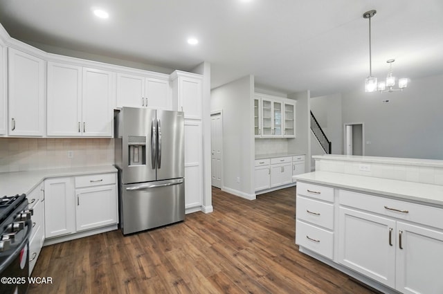1291 Madison Blvd, Van Wert, OH 45891 - kitchen featuring white cabinets, gas stove, decorative light fixtures, dark wood-type flooring, and stainless steel refrigerator with ice dispenser