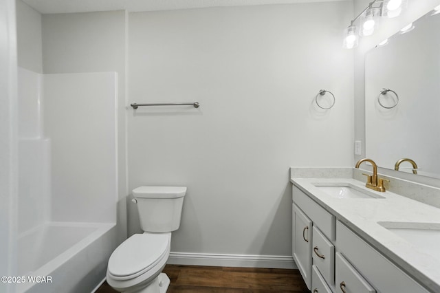 1291 Madison Blvd, Van Wert, OH 45891 - full bathroom with double vanity, wood finished floors, a sink, baseboards, and toilet