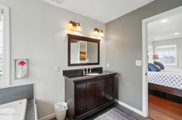 ensuite bathroom featuring ensuite bath, visible vents, baseboards, vanity, and recessed lighting