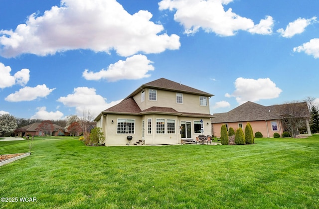 back of property featuring a patio area and a yard