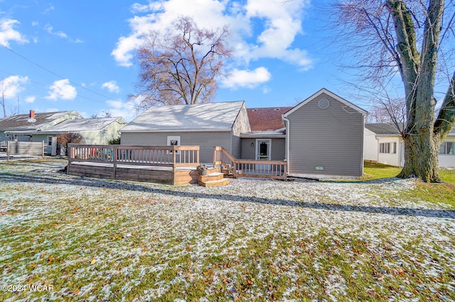 back of house featuring a wooden deck and a lawn