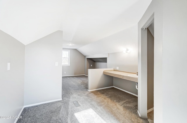 additional living space with lofted ceiling and carpet