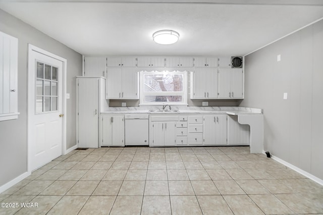 kitchen with white cabinetry, white dishwasher, light tile patterned flooring, and sink