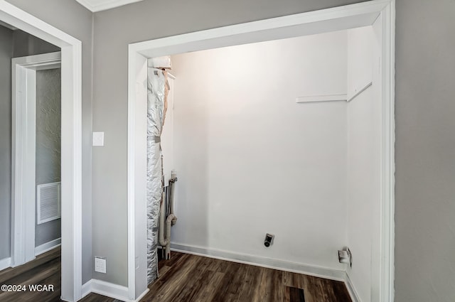 clothes washing area featuring electric dryer hookup and dark wood-type flooring