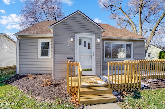 bungalow-style house with a wooden deck