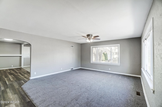 empty room featuring dark wood-type flooring and ceiling fan