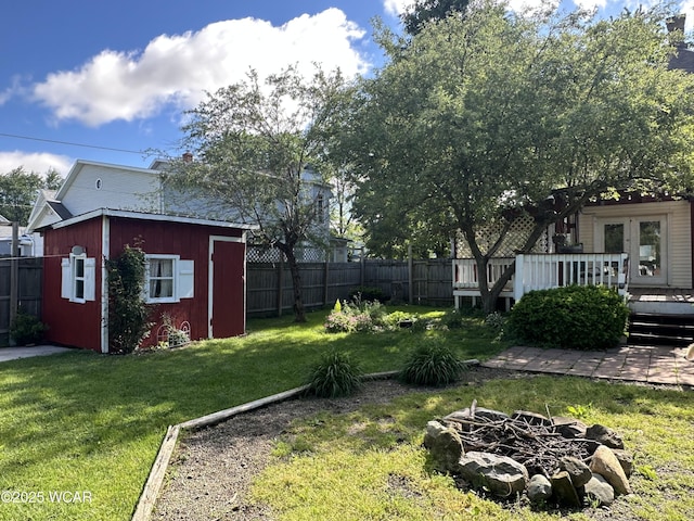 827 N Main St, Fostoria, OH 44830 - view of yard featuring a deck, an outbuilding, and an outdoor fire pit