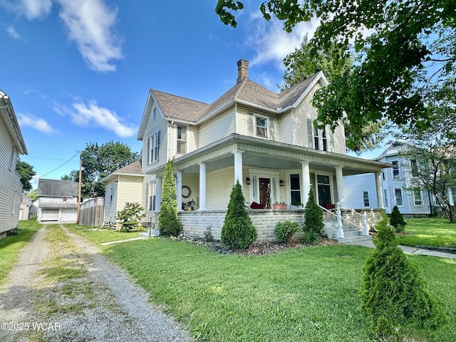 827 N Main St, Fostoria, OH 44830 - view of front of home with a chimney, covered porch, a front yard, and driveway