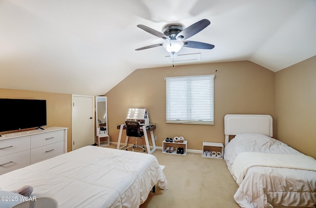 carpeted bedroom with ceiling fan and vaulted ceiling