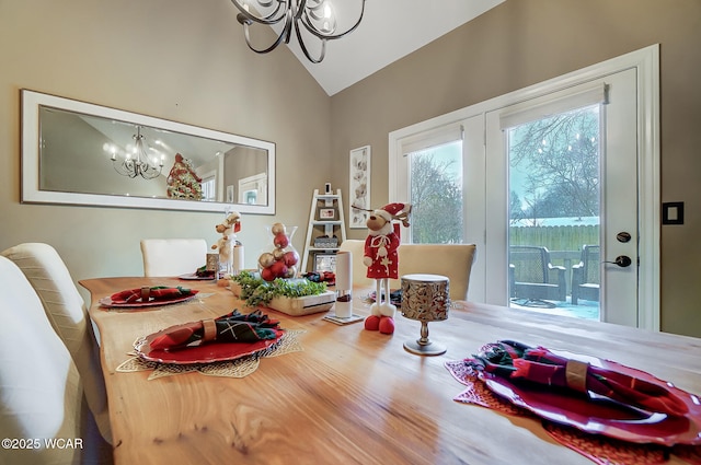 dining space featuring lofted ceiling and a chandelier