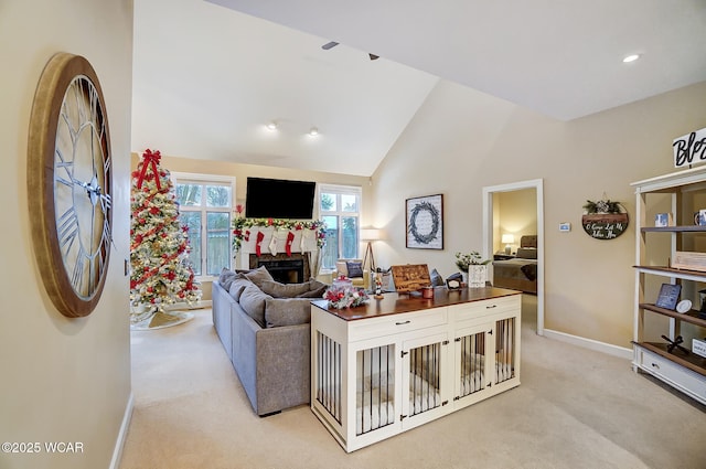 carpeted living room featuring high vaulted ceiling