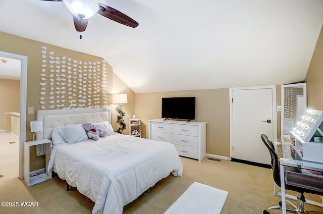 bedroom with ceiling fan, lofted ceiling, and light colored carpet