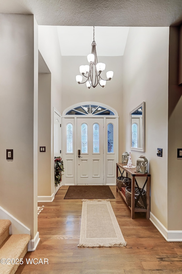 entrance foyer featuring hardwood / wood-style flooring and a chandelier