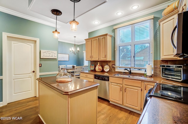 kitchen with pendant lighting, appliances with stainless steel finishes, backsplash, a kitchen island, and light brown cabinetry