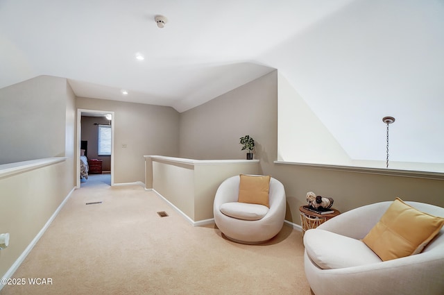 living area featuring light colored carpet and vaulted ceiling