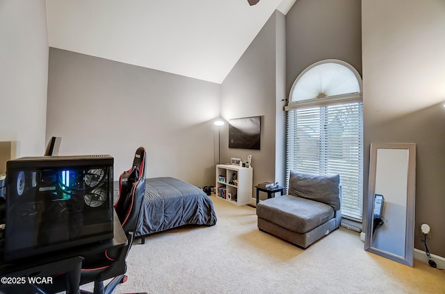 carpeted bedroom featuring high vaulted ceiling