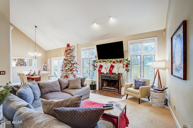 living room featuring an inviting chandelier, a wealth of natural light, high vaulted ceiling, and carpet