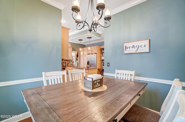 dining area featuring crown molding and an inviting chandelier