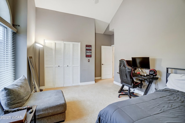 bedroom featuring light carpet, high vaulted ceiling, and a closet