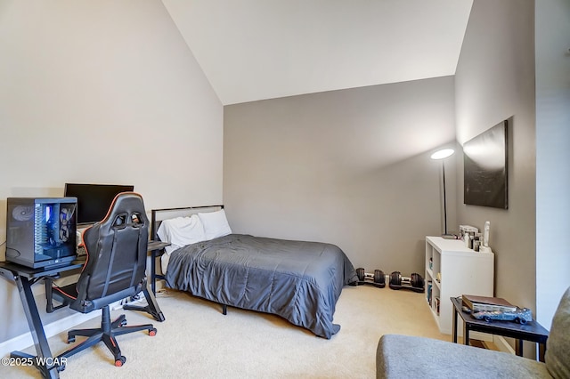 bedroom with vaulted ceiling and light carpet